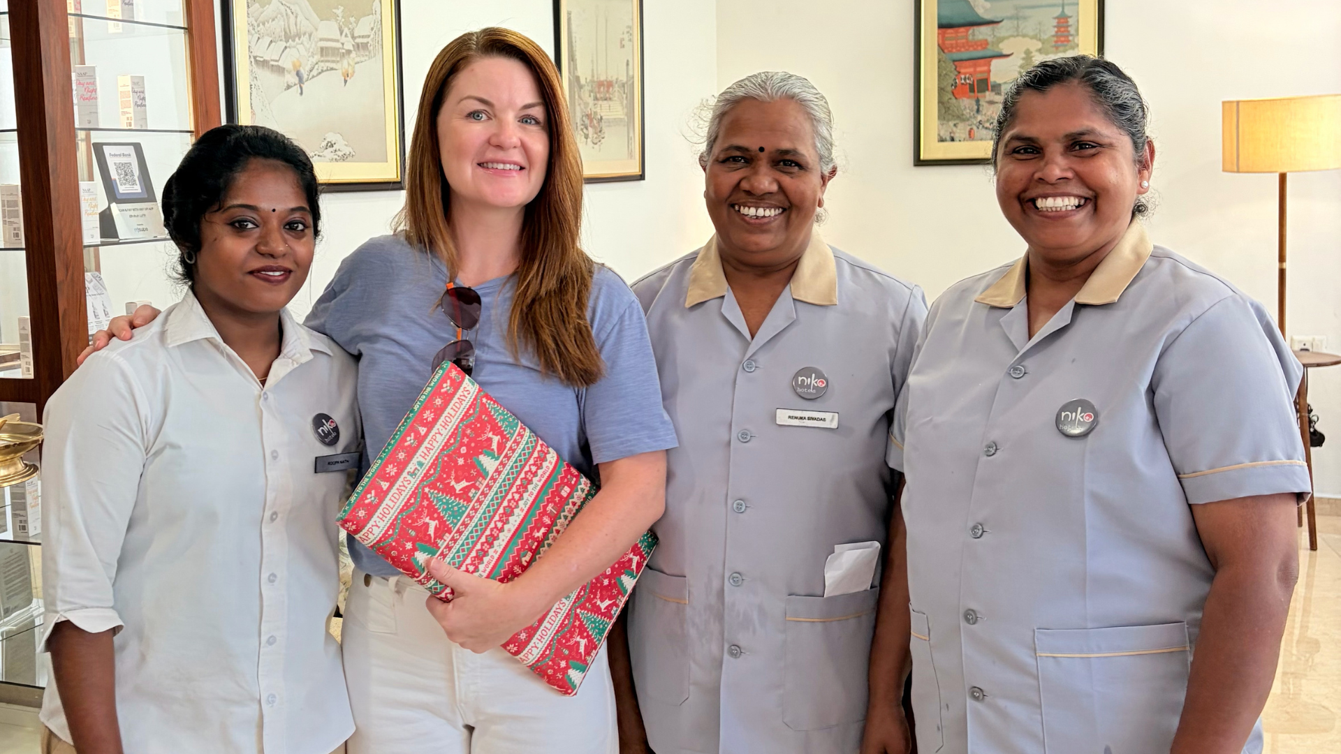 Photo of happy foreigner guest with staff at niko hotels in Kochi. This is why foreigners prefer niko hotels